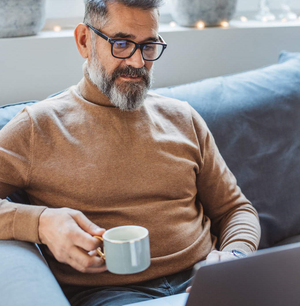 man with coffee and gray beard